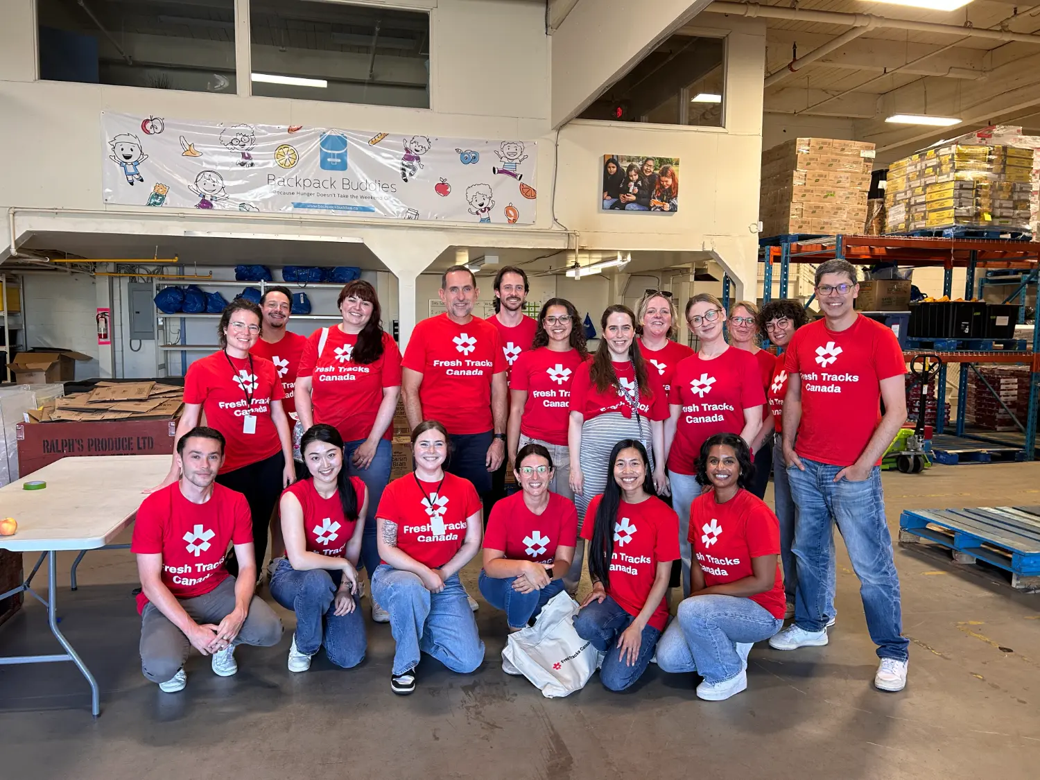 Fresh Tracks Canada team members volunteering with Backpack Buddies, helping make a positive impact in our community.