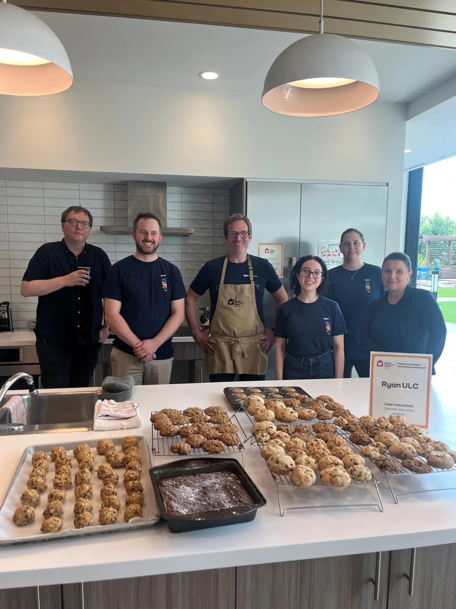 The Ryan Winnipeg office prepares baked goods at Ronald McDonald House Manitoba for RyanSHARES Day 2026.