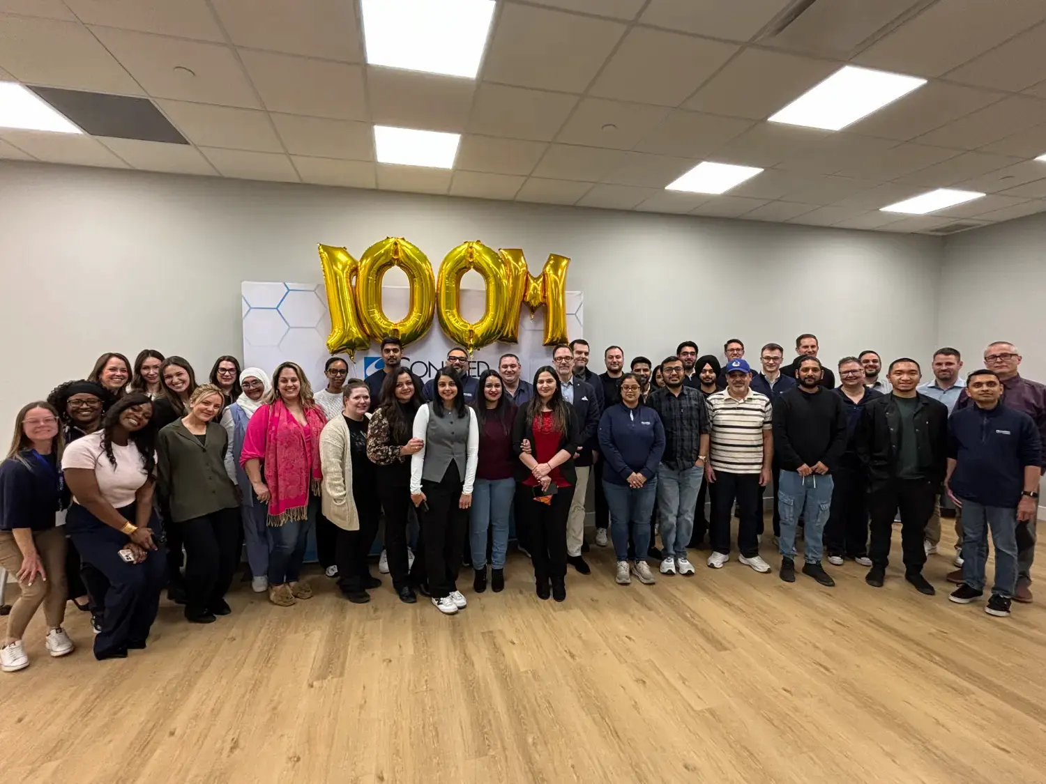 100 million event group picture following a celebration with leadership team and employees