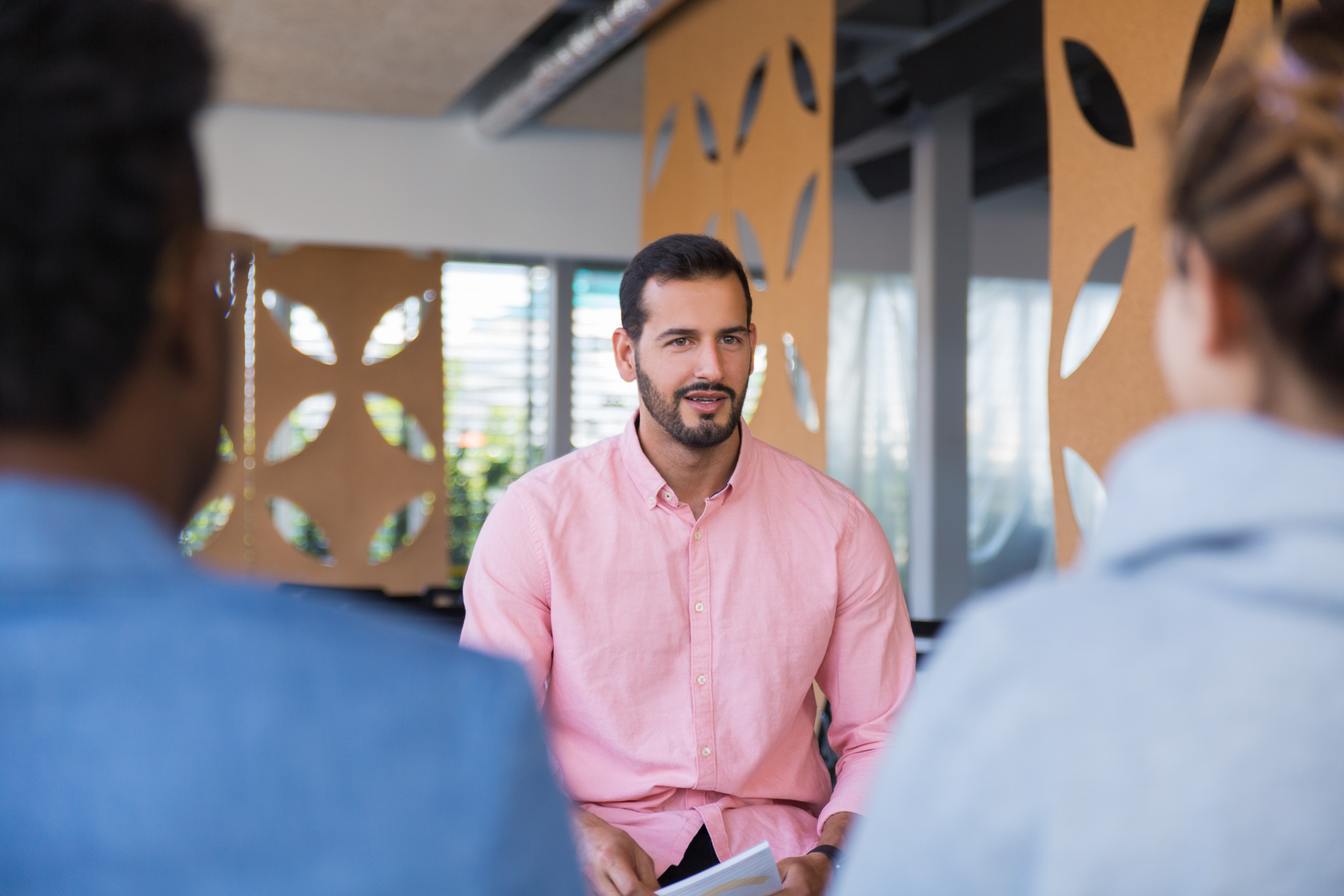 friendly confident business coach speaking before audience